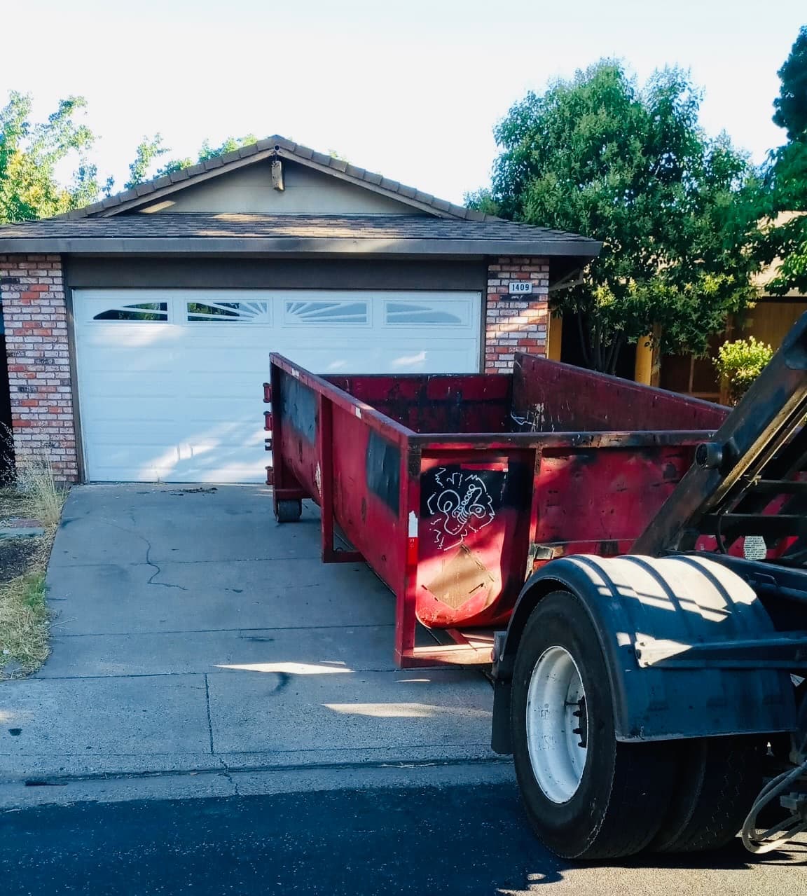 Dumpster being delivered to residential property for renovation